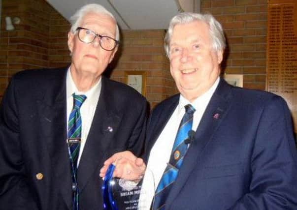 Melton Probus Club president Ron Marks (right) presents Brian Mills with the memento for his retirement PHOTO: Supplied