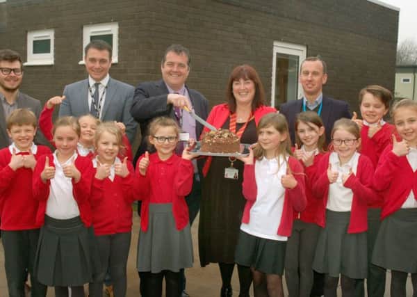Julia Hancock, head teacher at Asfordby Captain's Close Primary School, celebrates the opening of a new classroom with pupils, architects and the CEO of Discovery Schools Trust EMN-181104-142117001