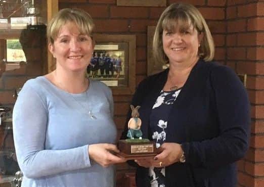 Vice-captain Karen presents lady captain Pam with the Rabbit Trophy EMN-181204-125647002