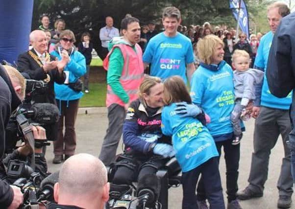 Claire Lomas hugs daughter Maisie after finishing the marathon in eight days EMN-180416-155818001