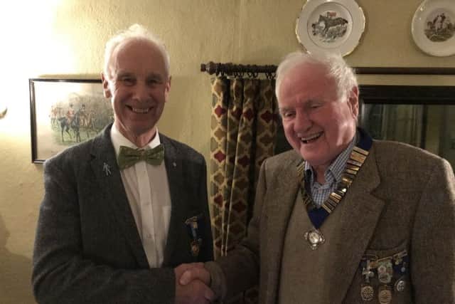 John Wood (right) being congratulated by outgoing chairman Tim Bryan PHOTO: Supplied