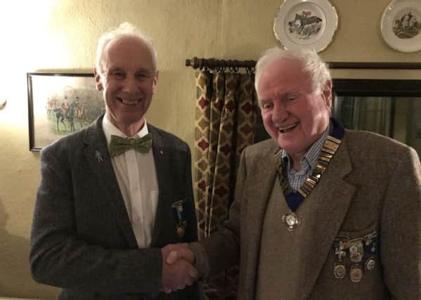 John Wood (right) being congratulated by outgoing chairman Tim Bryan PHOTO: Supplied