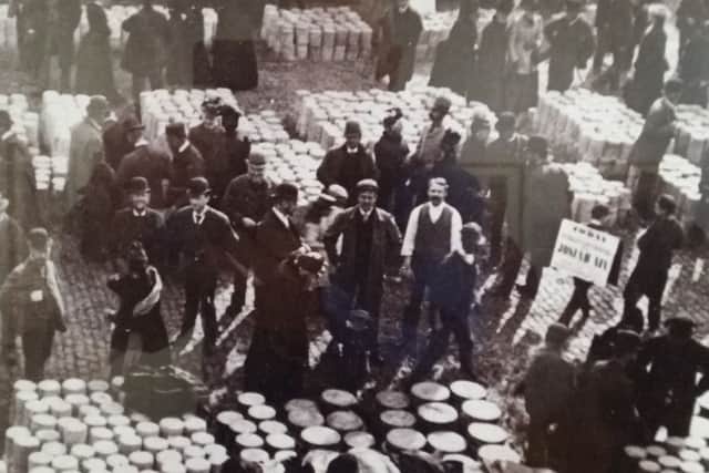 A cheese fair in Melton in 1910 - cheeses were stacked on straw in Market Place and some surrounding streets in the town EMN-180424-170801001