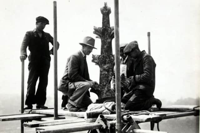 1933 photo of men performing maintenance work on the roof of St Mary's Church in Melton EMN-180424-170910001