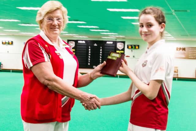Talented junior Izzy Pymm receives the ladies trophy from new president Pat Wright EMN-180430-181504002