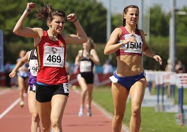 Mari raises her arms in triumph as she pips top Scottish prospect Mhairi Hendry in the 800m final EMN-180515-115937002