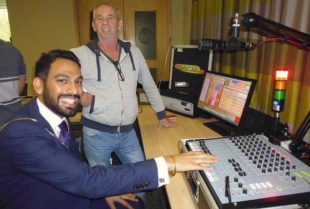 Melton Mayor councillor Tejpal Bains tries out some of the studio equipment demonstrated by Philip Furnival from broadcast engineering company Transplan UK PHOTO: Supplied