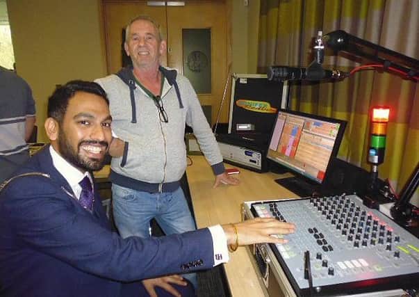 Melton Mayor councillor Tejpal Bains tries out some of the studio equipment demonstrated by Philip Furnival from broadcast engineering company Transplan UK PHOTO: Supplied