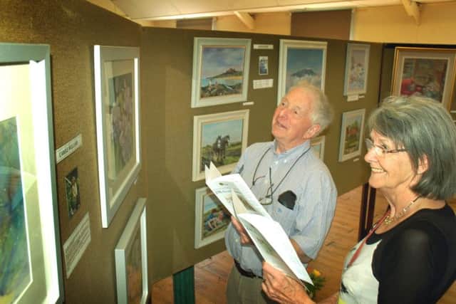 John and Jackie Phillips make their way around the village hall exhibits PHOTO: Tim Williams