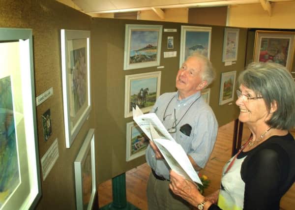 John and Jackie Phillips make their way around the village hall exhibits PHOTO: Tim Williams