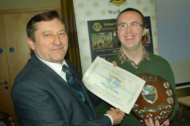 Edward Kitchen receives Monday Mencap's award from Lion Geoff Tate PHOTO: Tim Williams