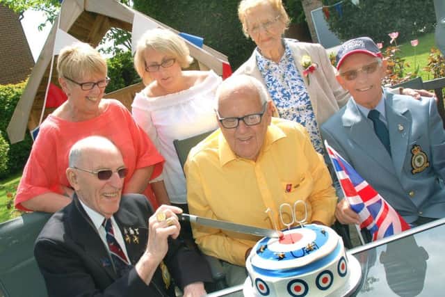 Residents cut their cake with warden Maggie Hill and deputy warden Mandy Hill at a garden party at Wexford House in Melton to celebrate the 100th anniversary of the founding of the RAF EMN-180521-173257001