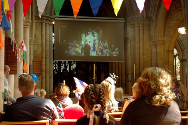 The well-dressed audience watch the big screen in St Mary's Church PHOTO: Tim Williams