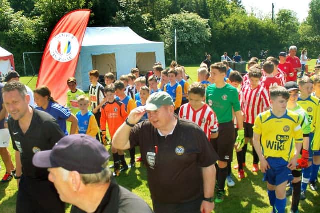 The teams parade onto the pitch for the opening ceremony. EMN-180522-120925002