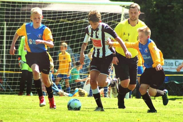 Under 12s winners Mowbray Rangers (yellow and blue) take on French visitors Etoile EMN-180522-120945002