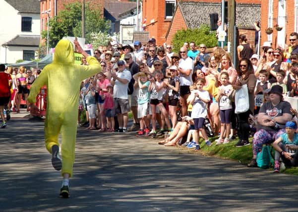 One of the ducks is cheered on at the finish of the five-mile race PHOTO: Tim Williams