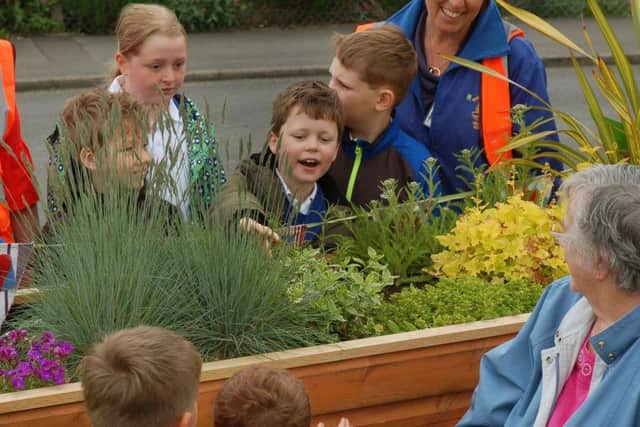 Bottesford Primary School pupils admire flower beds around the Friendly Bench EMN-180523-170239001