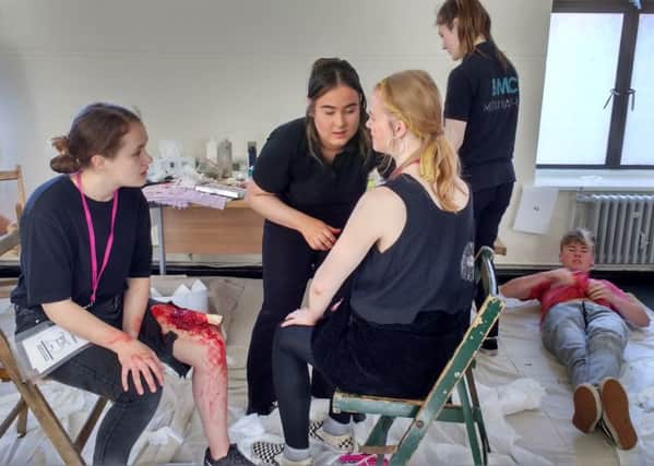 Performing Arts students are made to look like realistic casualties by Hair and Media Make-Up students at a simulated air crash incident EMN-180406-124339001