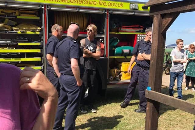 Bass guitarist Duff McKagan talks to Melton firefighters PHOTO: Stapleford Miniature Railway