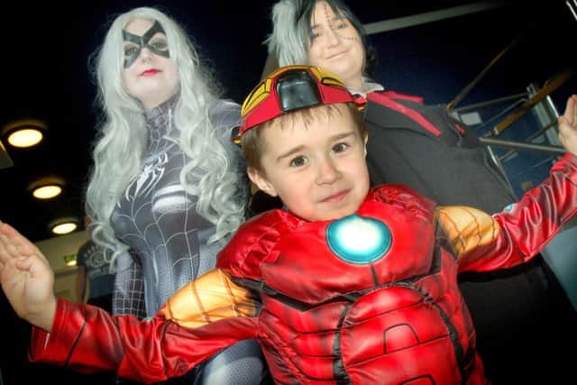 Six-year-old Iron Man Alfie Wyatt meets the Black Cat and Black Jack, aka sisters Sarah and Sophie Toth PHOTO: Tim Williams
