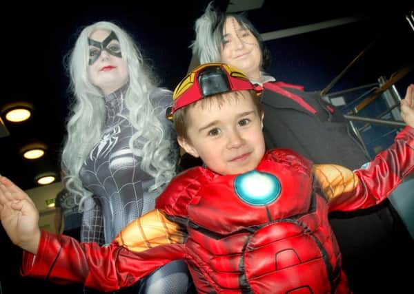 Six-year-old Iron Man Alfie Wyatt meets the Black Cat and Black Jack, aka sisters Sarah and Sophie Toth PHOTO: Tim Williams