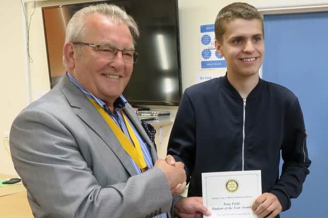 Harry being presented with his certificate and cheque by Rotarian Jim Schofield, vice president of the Rotary Club of Melton Mowbray Belvoir PHOTO: Supplied