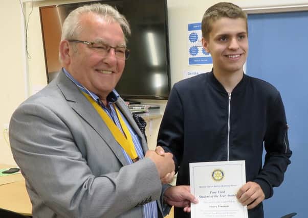Harry being presented with his certificate and cheque by Rotarian Jim Schofield, vice president of the Rotary Club of Melton Mowbray Belvoir PHOTO: Supplied