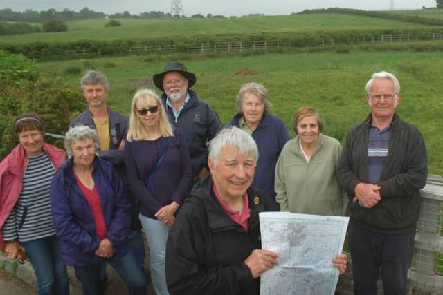 Mick Clowes and colleagues from the Melton and Oakham Waterways Society pictured on Lag Lane off the B676 - the route of the former canal they want to restore follows the hedge in the background EMN-180406-103533001