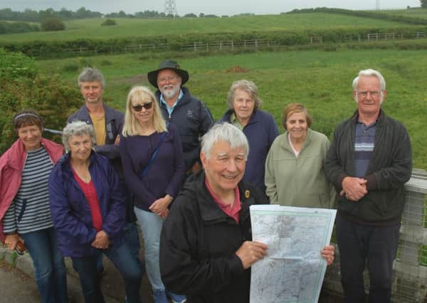 Mick Clowes and colleagues from the Melton and Oakham Waterways Society pictured on Lag Lane off the B676 - the route of the former canal they want to restore follows the hedge in the background EMN-180406-103533001