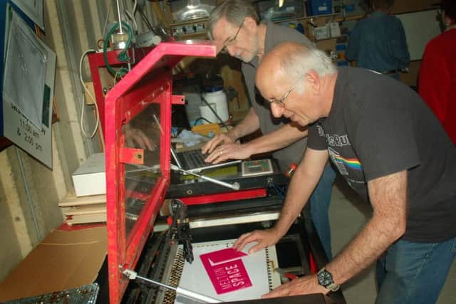 Barry Gilchrist abd Dave Shearer busy on their laser cutter at a Melton Space session EMN-180806-095156001