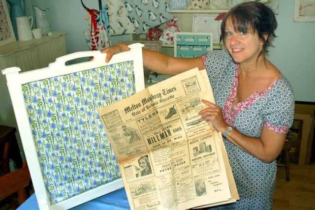 Karen Antcliffe with the 1935 copies of the Melton Times she found on the back of an old fire screen EMN-181106-174435001