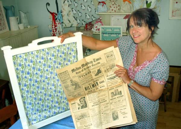 Karen Antcliffe with the 1935 copies of the Melton Times she found on the back of an old fire screen EMN-181106-174435001