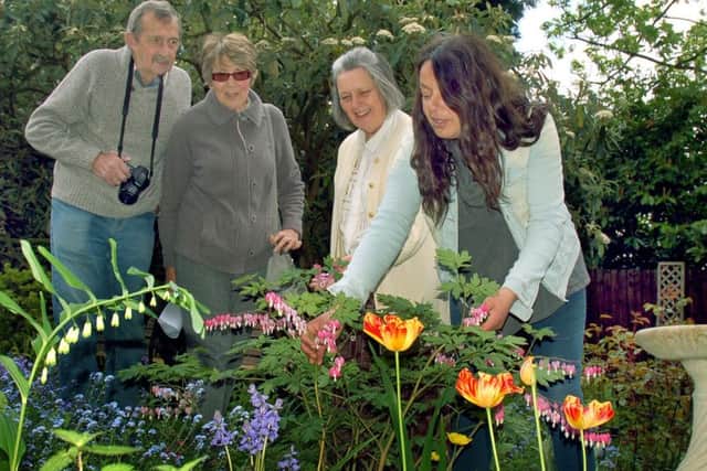 Owner Alison Blythe shows Alan and Carole Hewitt around the flower beds with horticultural expert Christina Moulton PHOTO: Tim Williams