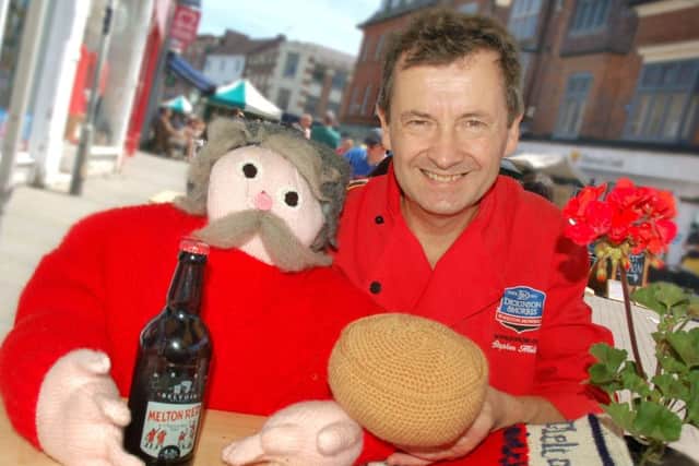 Stephen Hallam, MD of Melton's Dickinson and Morris Ye Olde Pork Pie Shoppe finds a woolly friend at the Paint The Town Red event EMN-180625-125554001