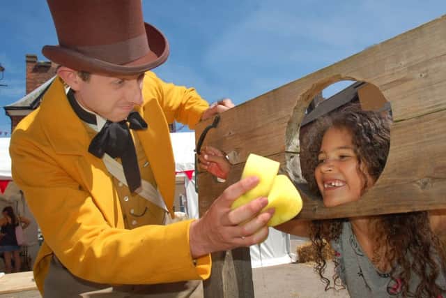 Isabella Cook, who is six, gets a sponging from The Marquis of Waterford, aka historical re-enactment specialist Jed Jaggard, during Paint The Town Red EMN-180625-125637001
