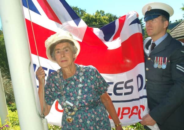 Mayor of Melton, Councillor Pru Chandler, hoists the flag, helped by Corp Melvin Whyte, from the Defence Animal Centre, at the Armed Forces Day ceremony outside the Melton Council offices EMN-180625-151813001