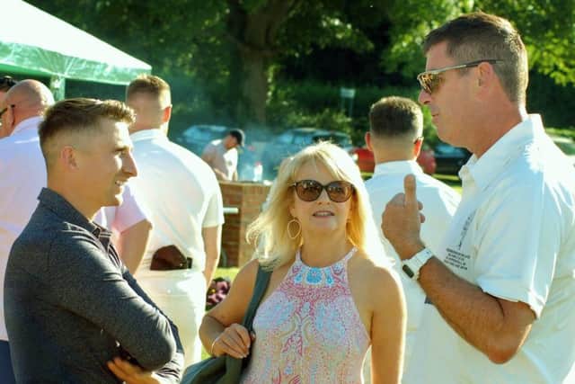Belvoir Castle Cricket and Countryside Trust director Darren Bicknell chats with former England batsman James Taylor who signed copies of his new book at the match EMN-180626-154401002