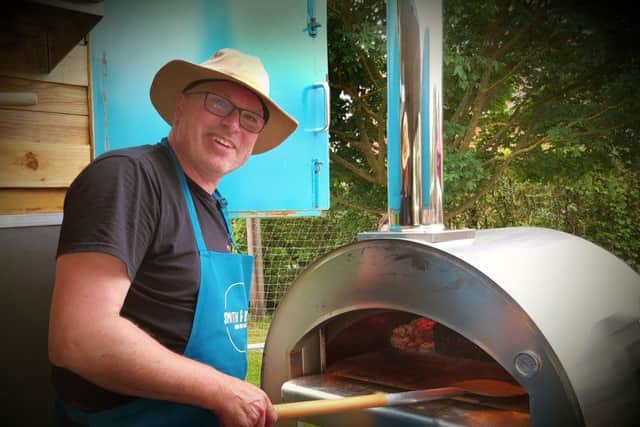 Rob Smith fires up the pizza oven PHOTO: Martin Fagan