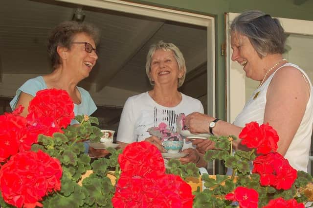 Members of Burton Lazars Flower Club Frances Waite and Fay Brook enjoy a cuppa with Tresillian House owner Alison Blythe PHOTO: Tim Williams