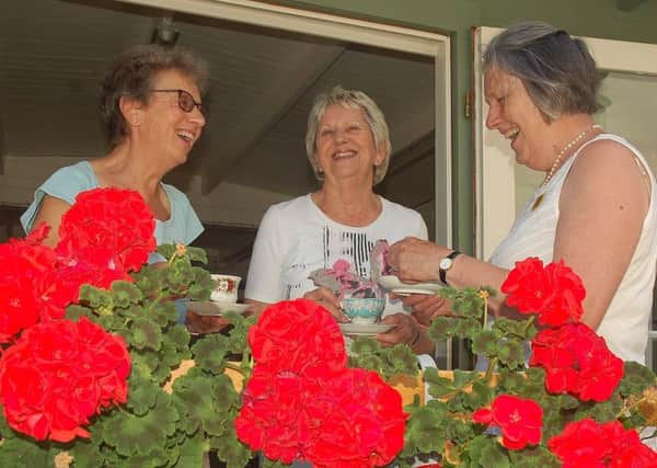 Members of Burton Lazars Flower Club Frances Waite and Fay Brook enjoy a cuppa with Tresillian House owner Alison Blythe PHOTO: Tim Williams