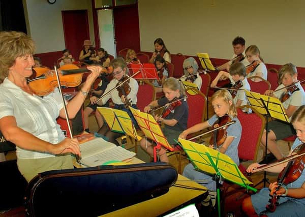 Zosia Cocker with school violinists PHOTO: Tim Williams