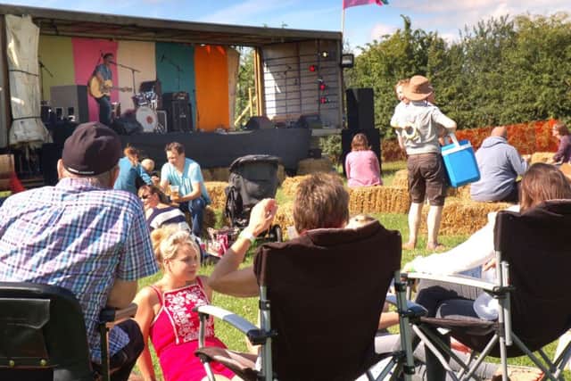 A crowd enjoy the music and evening sunshine PHOTO: Tim Williams