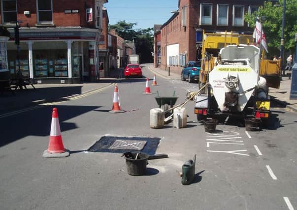 Workmen do preparatory work on manholes in Leicester Street prior to repairs being made to stop them rattling.
PHOTO JOHN ARTHUR EMN-180627-142301001