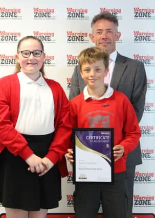 Brownlow Primary School head teacher Damien Turrell and two pupils receive their Beyond Bullying Award at a ceremony at Leicestershire County Council EMN-180407-131602001