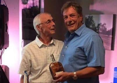 Ray Smith (left) receives his winner's prize from captain Glenn Price EMN-180207-193350002