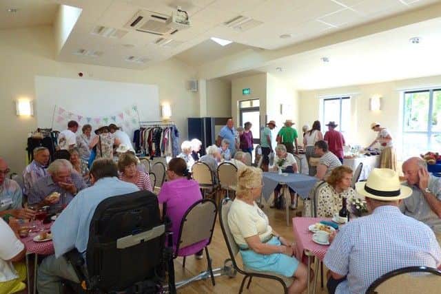 Fete-goers enjoy refreshments and stalls in the village hall PHOTO: Supplied