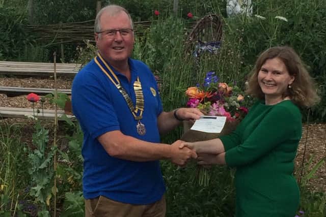 Adrian Cresswell, Vale of Belvoir Rotary Club president, presents a cheque to Julia Sandhu, Reach fundraiser PHOTO: Supplied
