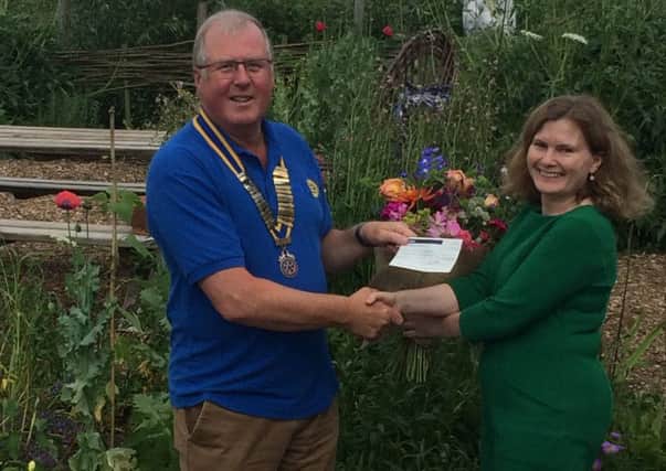 Adrian Cresswell, Vale of Belvoir Rotary Club president, presents a cheque to Julia Sandhu, Reach fundraiser PHOTO: Supplied
