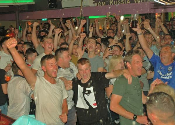 Regulars at The Cutting Room in Melton celebrate at the final whistle after watching on a big screen at the pub as England beat Sweden to reach the World Cup semi-finals EMN-180907-103657001