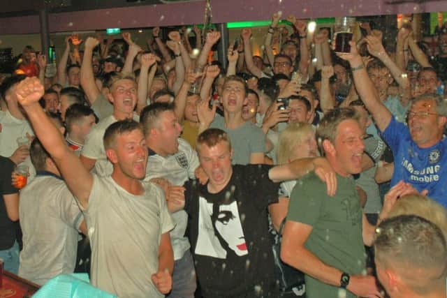 Regulars at The Cutting Room in Melton celebrate at the final whistle after watching on a big screen at the pub as England beat Sweden to reach the World Cup semi-finals EMN-180907-103657001